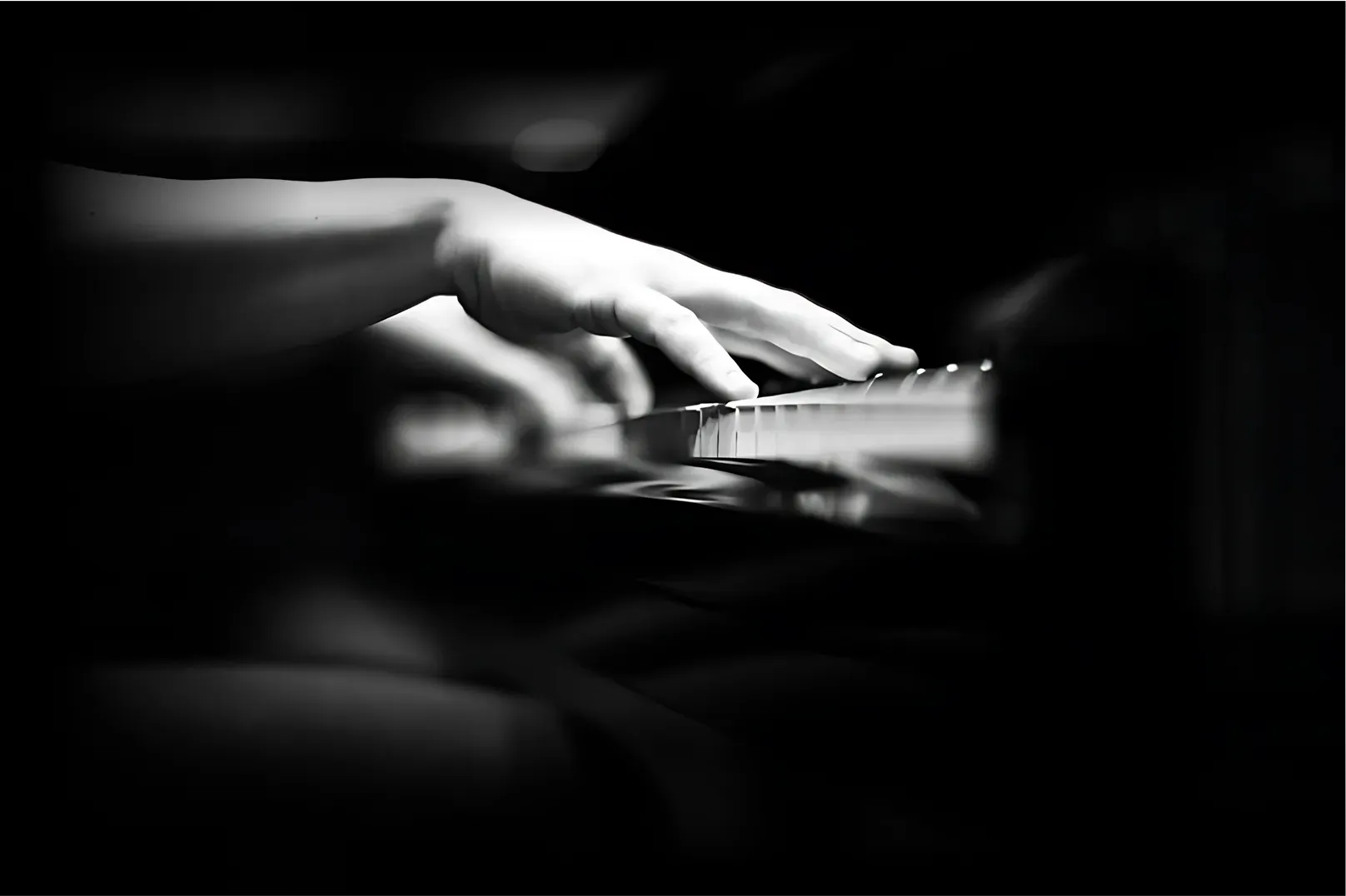 Hands playing piano keys